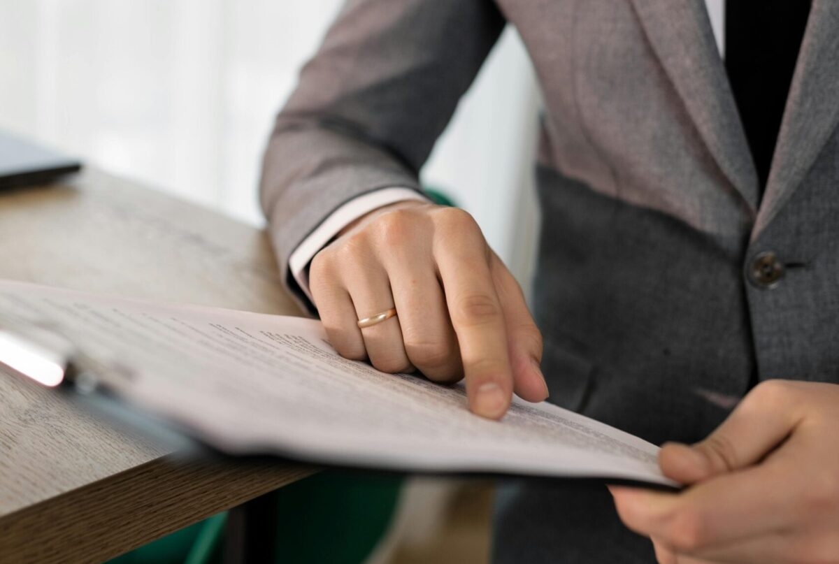 Professional reviewing document on a clipboard.