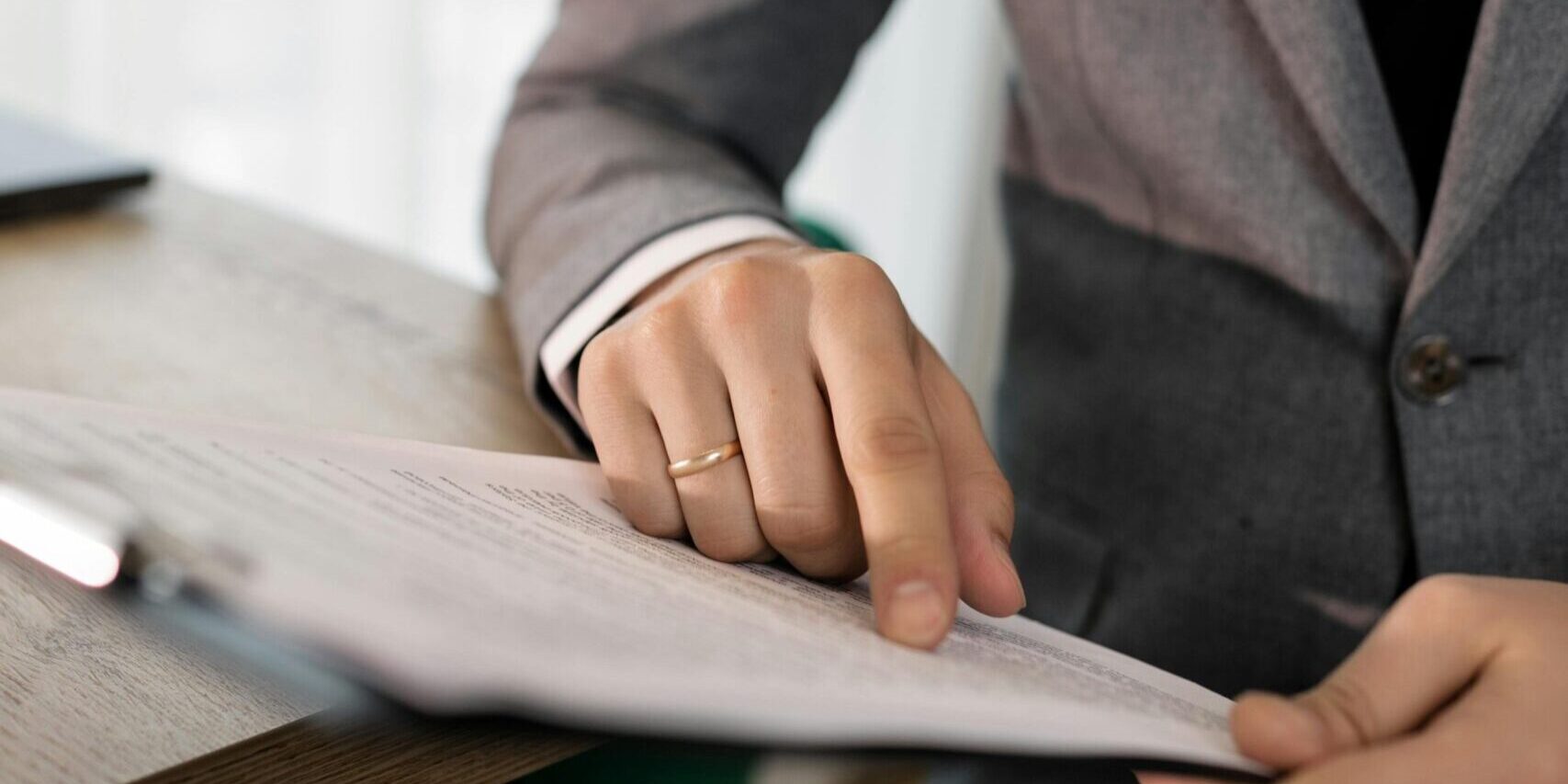 Professional reviewing document on a clipboard.