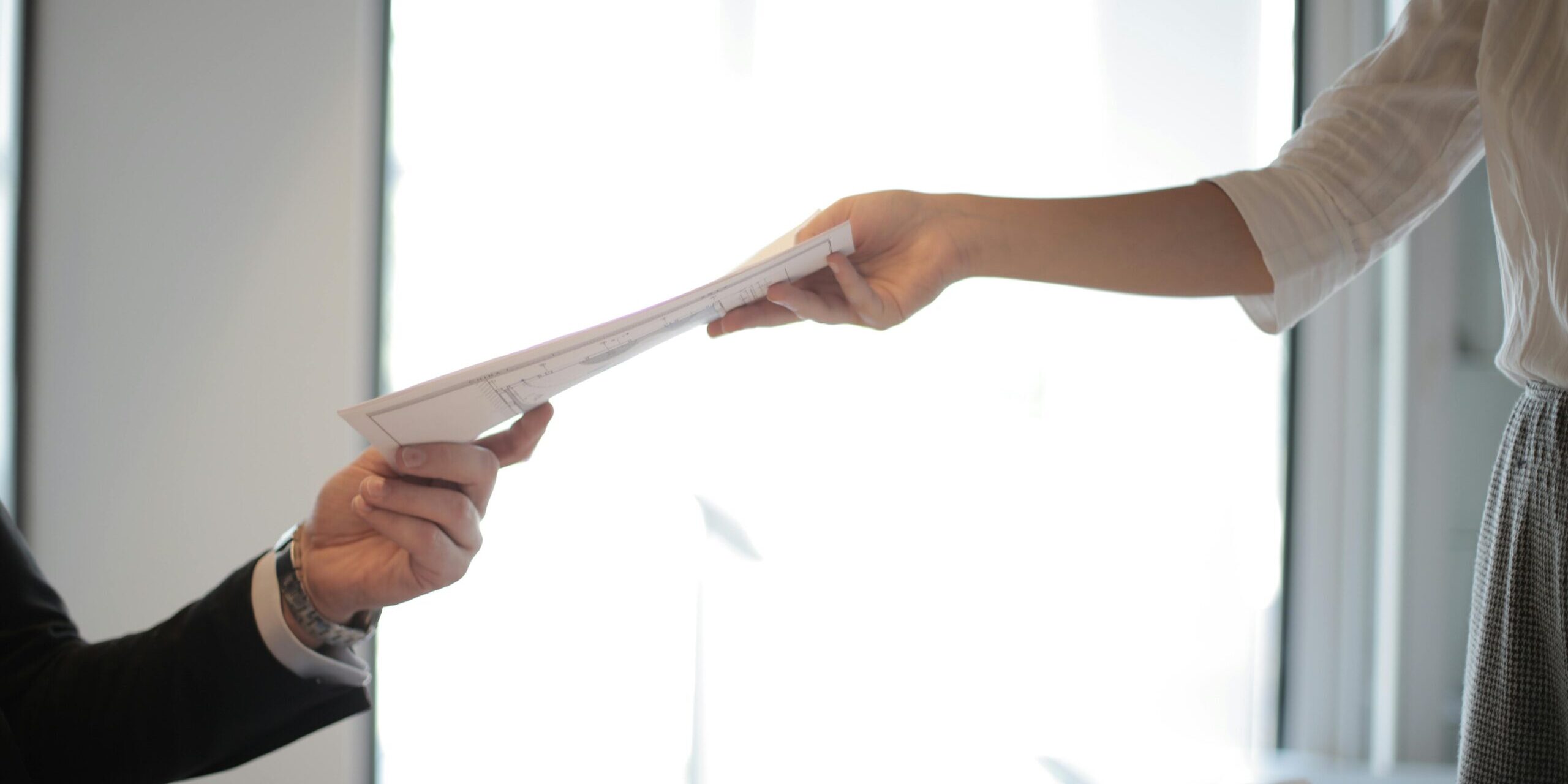 An individual handing over a document.