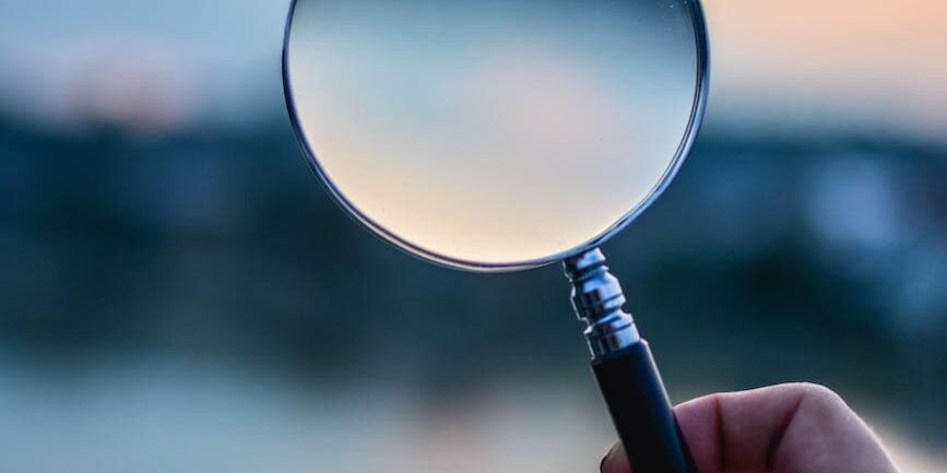 selective focus photo of magnifying glass