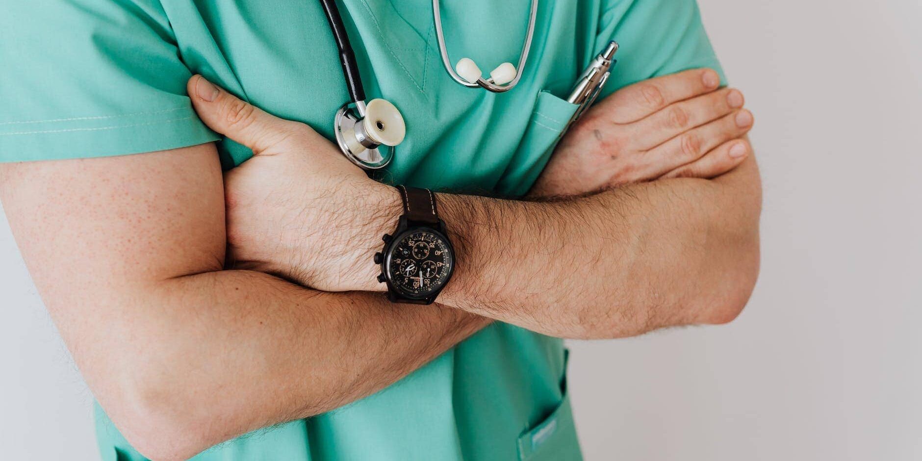 unrecognizable crop man in wristwatch with stethoscope