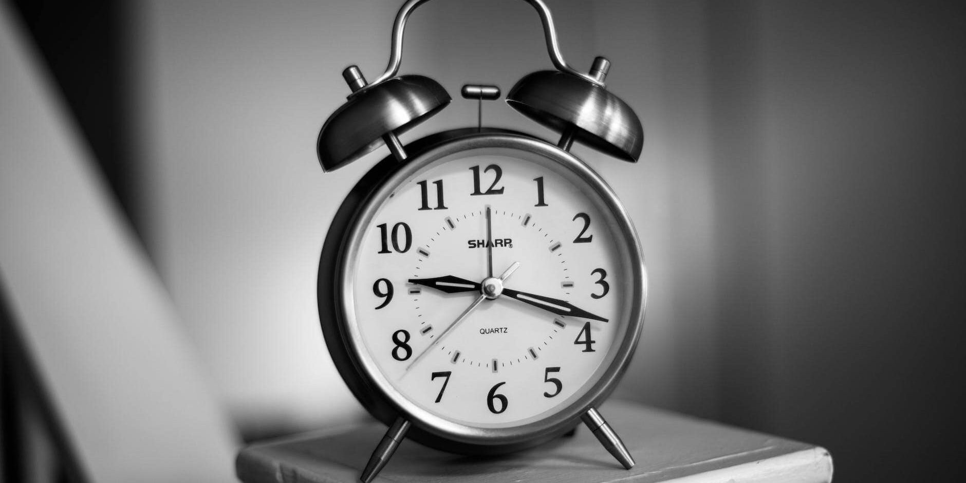 grayscale photo of twin bell alarm clock