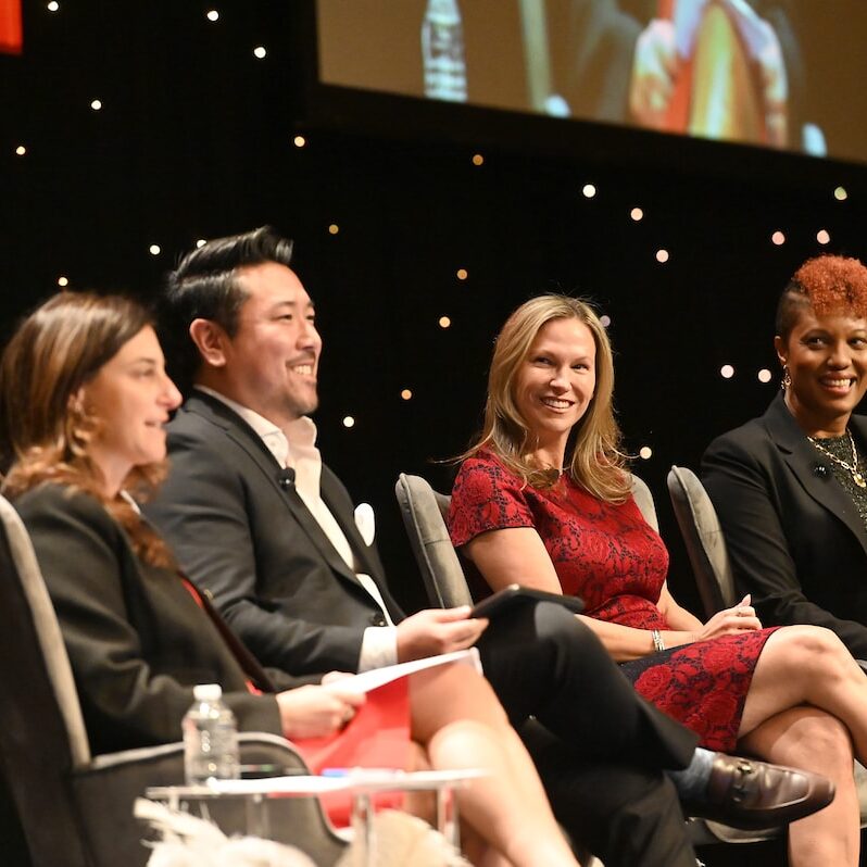 Group of PLUS speakers on stage at the PLUS Conference