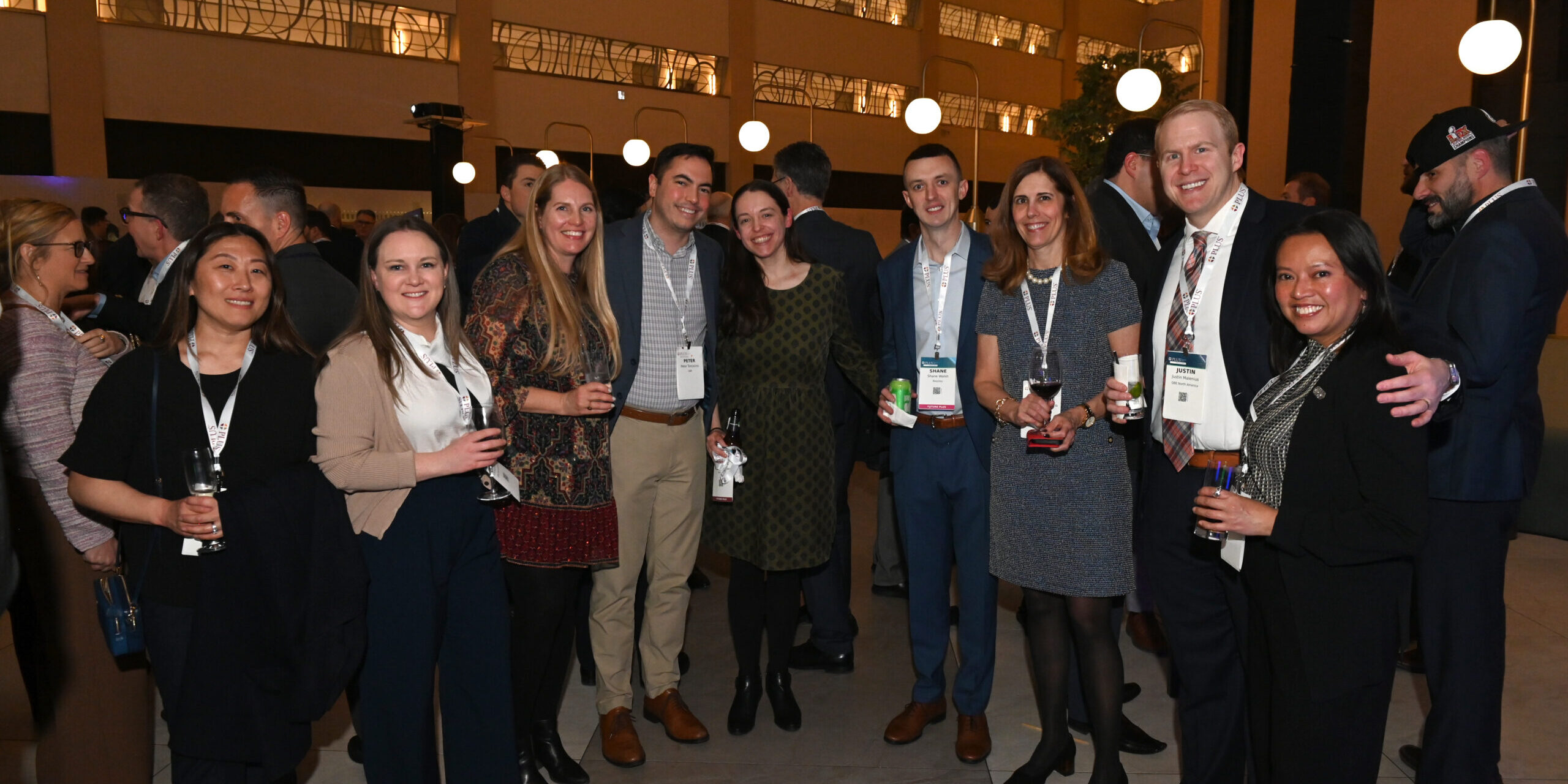 A group of 8 attendees from the PLUS Symposia Series in NYC.