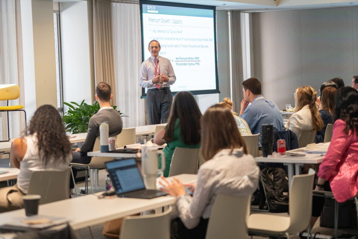 A speaker at the 2024 PLUS University in Chicago with a room full of attendees.