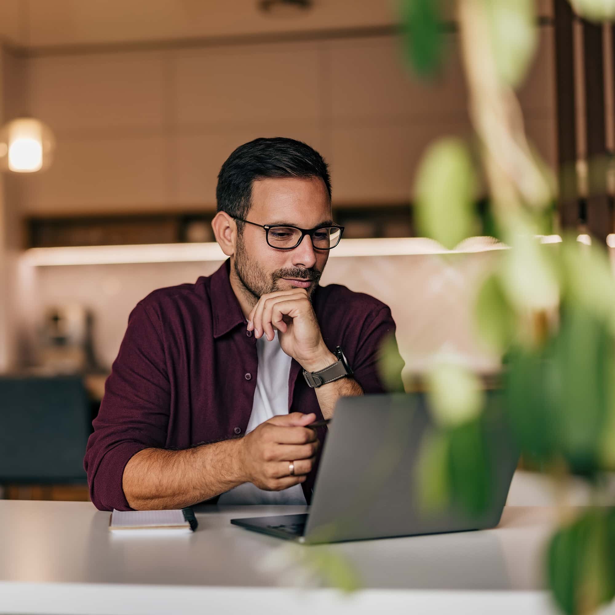 A man working online, over the laptop, having a meeting, talking to his clients.