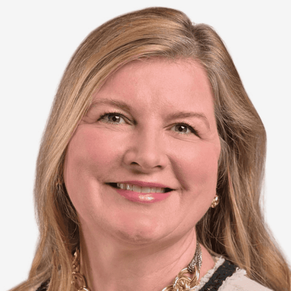 Headshot of Alison Martin from the shoulders up, smiling, wavy hair