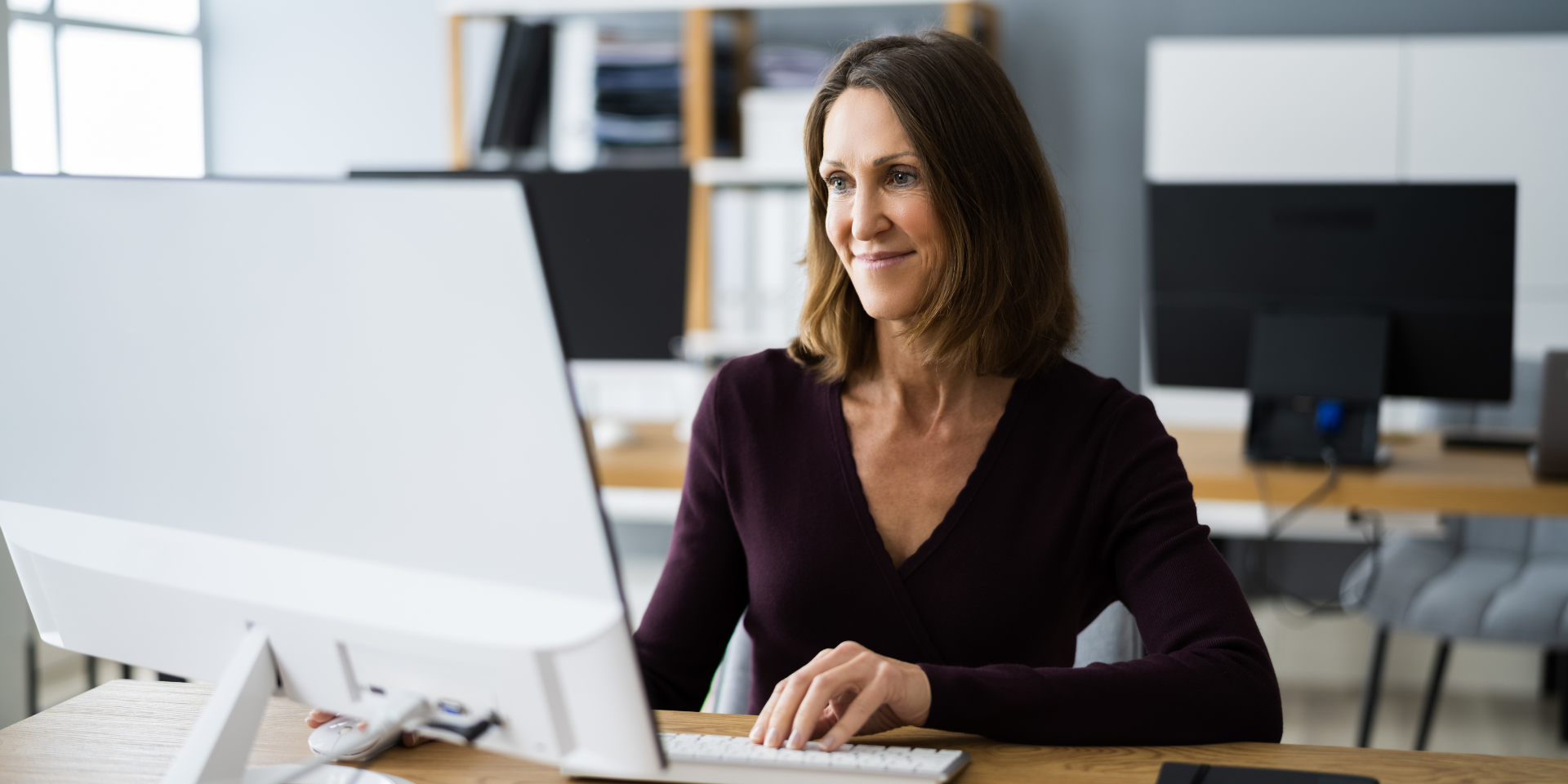 An image of a woman typing on her laptop.