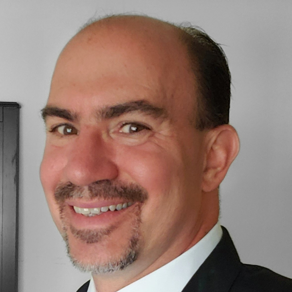 Headshot of John Favilla. Smiling from the neck up