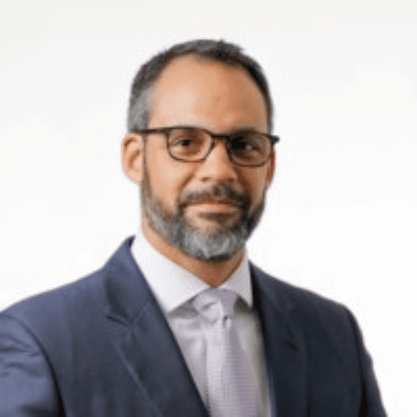 Headshot of Richard B. Porter. Wearing a gray suit and glasses from the chest up