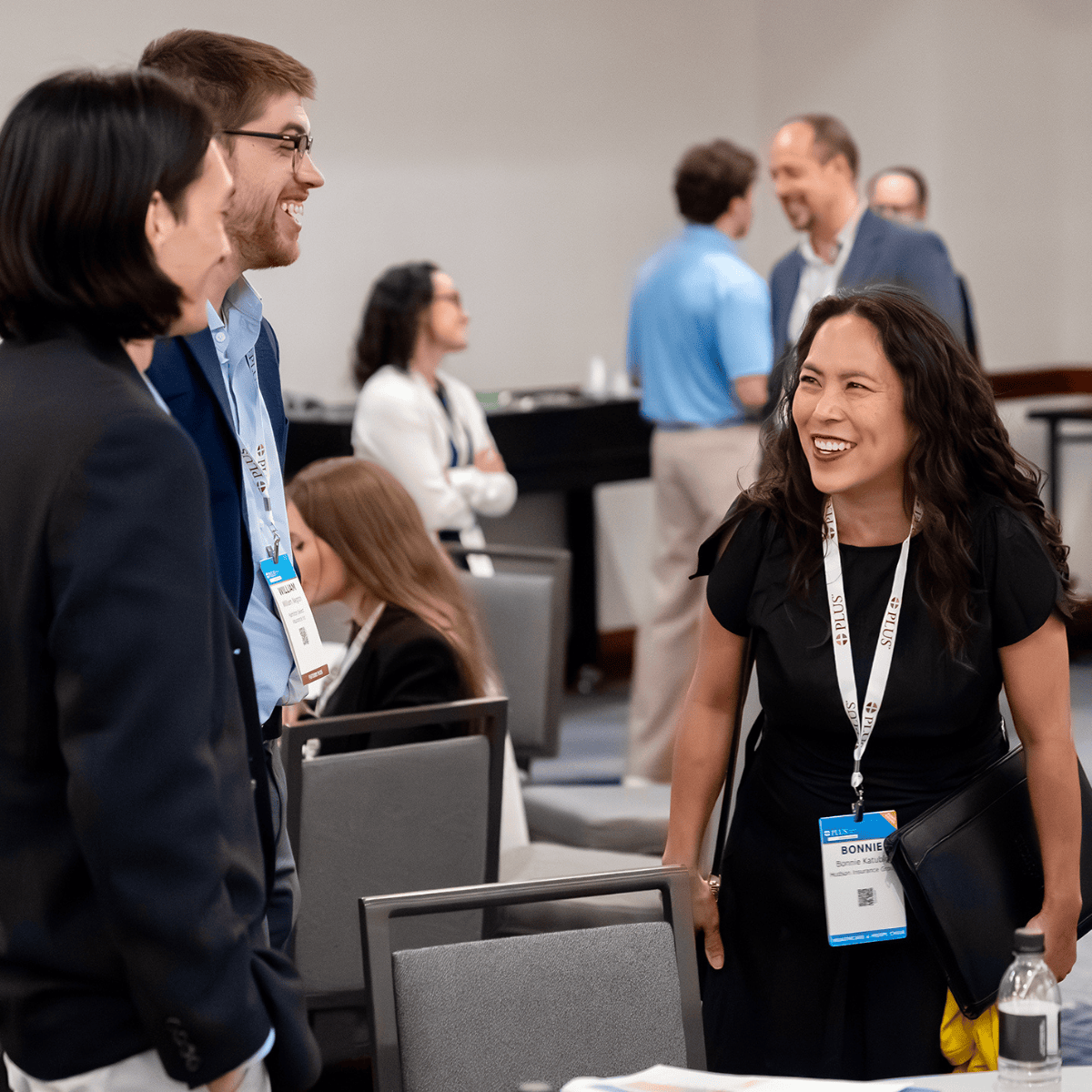 Photo of PLUS members laughing and smiling at a PLUS event.