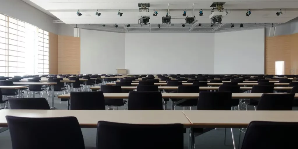 Empty conference room with large whiteboard and projectors